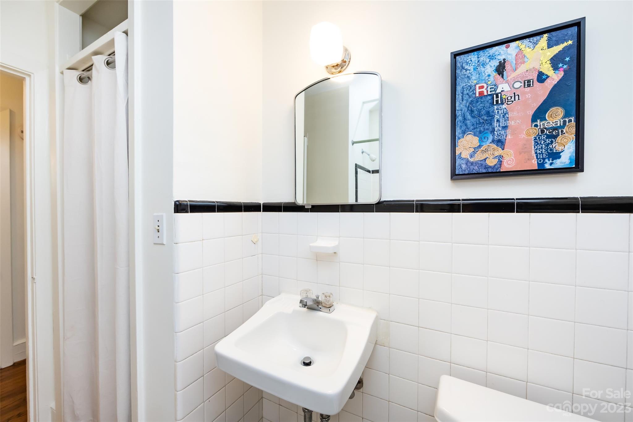 1011 Andover Road Charlotte, NC 28211 - Photo 21 of 29 a bathroom with a sink and a mirror
