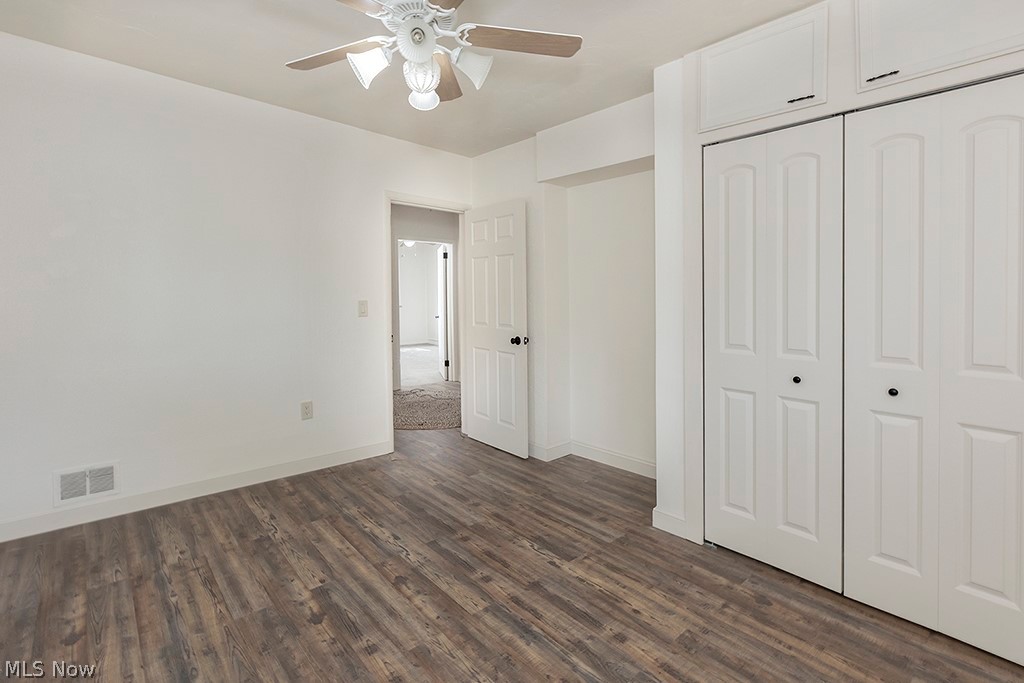 3090 Warren Road Cleveland, OH 44111 - Photo 28 of 50 Unfurnished bedroom featuring dark hardwood / wood-style floors, ceiling fan, and a closet