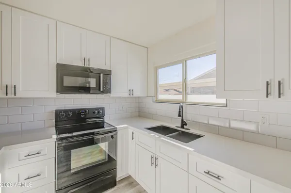 a kitchen with a sink and cabinets