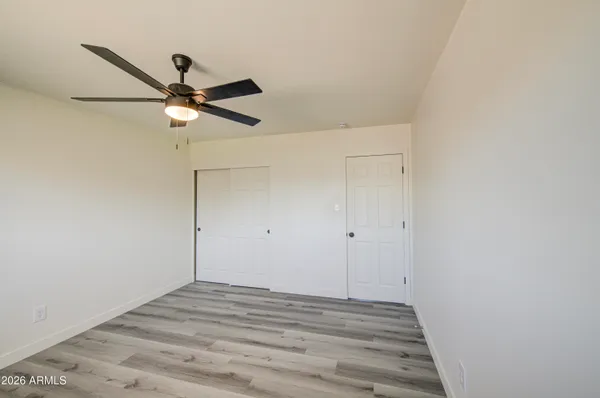 a view of a room with wooden floor
