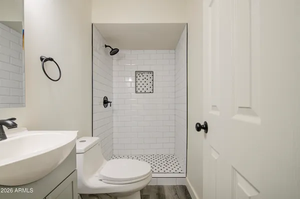 a white toilet sitting next to a bathroom sink