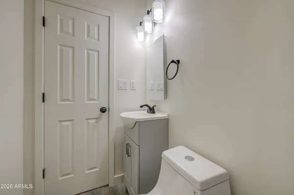 a bathroom with a toilet a sink and mirror