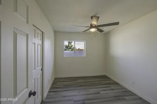 a view of a hallway with a chandelier fan