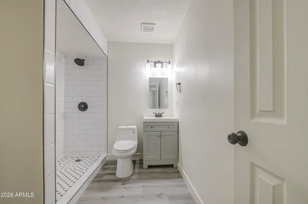a bathroom with a toilet sink and shower
