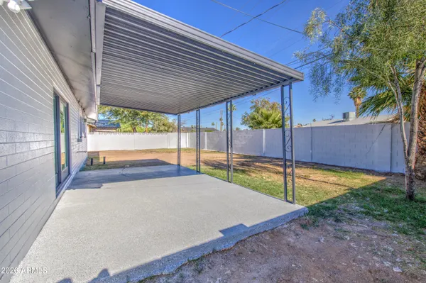 a view of a backyard with large trees and a small yard