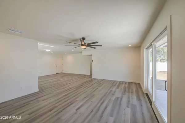 wooden floor in an empty room with a window