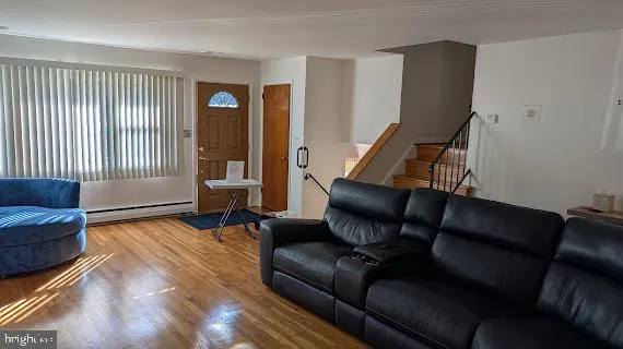 a living room with furniture and wooden floor