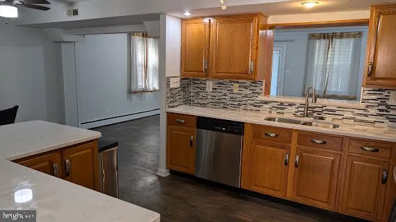 a kitchen with stainless steel appliances granite countertop wooden cabinets a sink and dishwasher