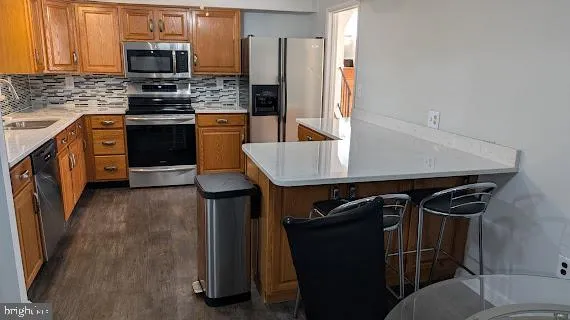 a kitchen with stainless steel appliances and wood cabinets