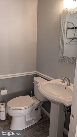 a white toilet sitting next to a bathroom sink