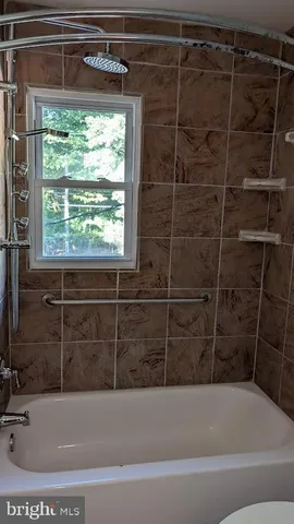 a bathroom with a bathtub and window