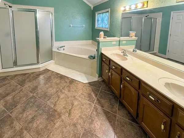 a spacious bathroom with a granite countertop sink and a mirror
