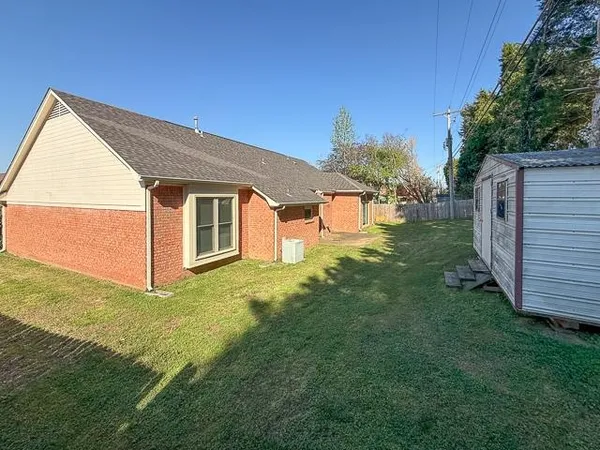 a backyard of a house with lots of green space and outdoor seating