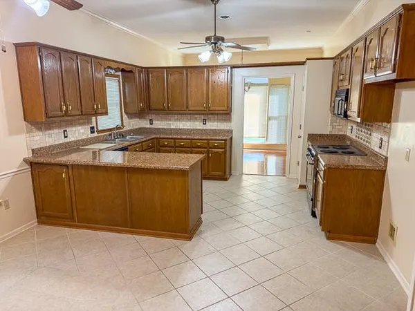 a kitchen with stainless steel appliances granite countertop a stove sink and cabinets