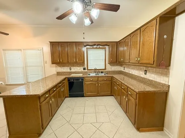 a kitchen with stainless steel appliances granite countertop a sink counter space cabinets and a large window