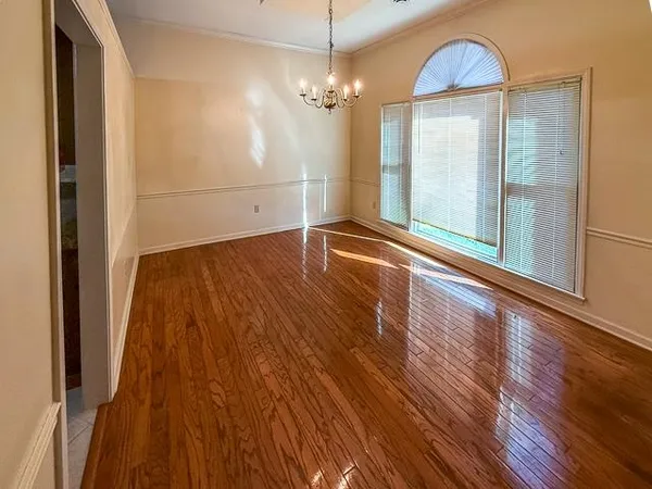 a view of a room with wooden floor