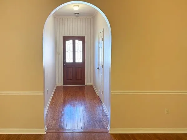 a view of front door with wooden floor