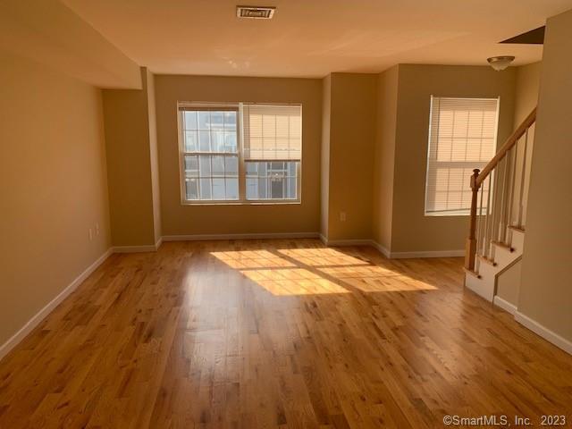 27 Tridell Drive, Unit 14 Plantsville, CT 06479 - Photo 4 of 12 an empty room with wooden floor and windows