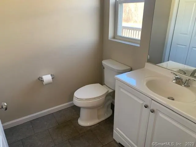 a white toilet sitting next to a bathroom sink