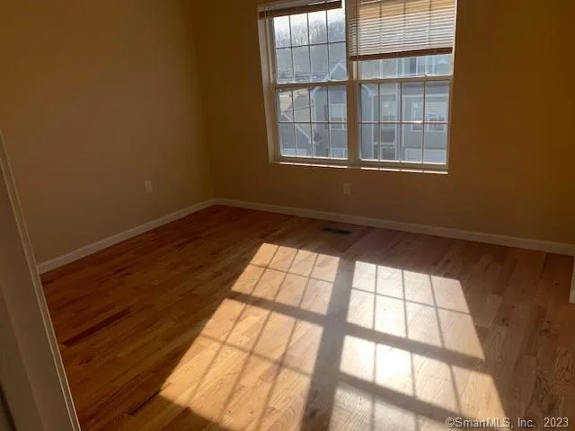 a view of an empty room and a window