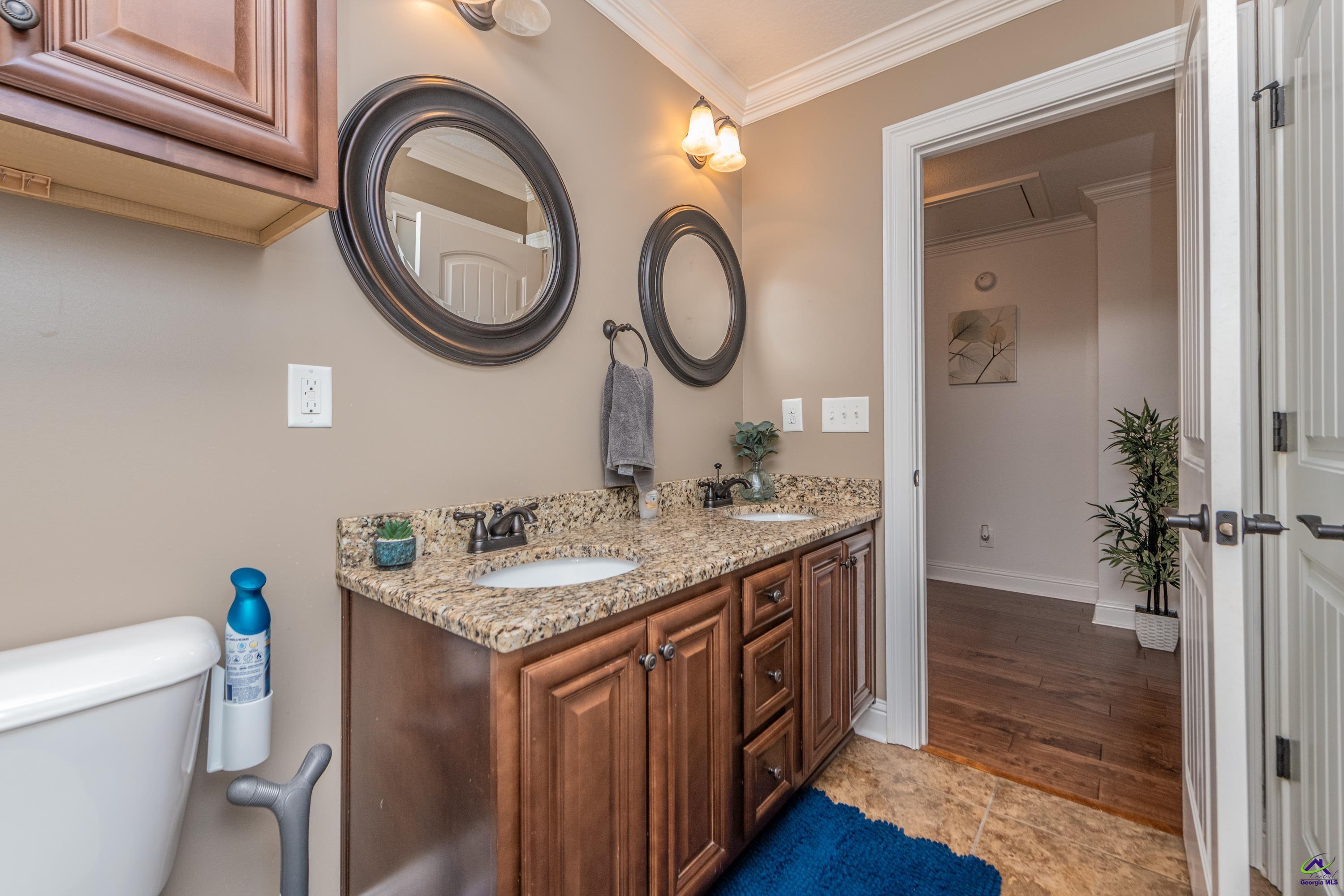 405 Old Bridge Road Warner Robins, GA 31088 - Photo 49 of 58 a bathroom with a granite countertop toilet sink and mirror
