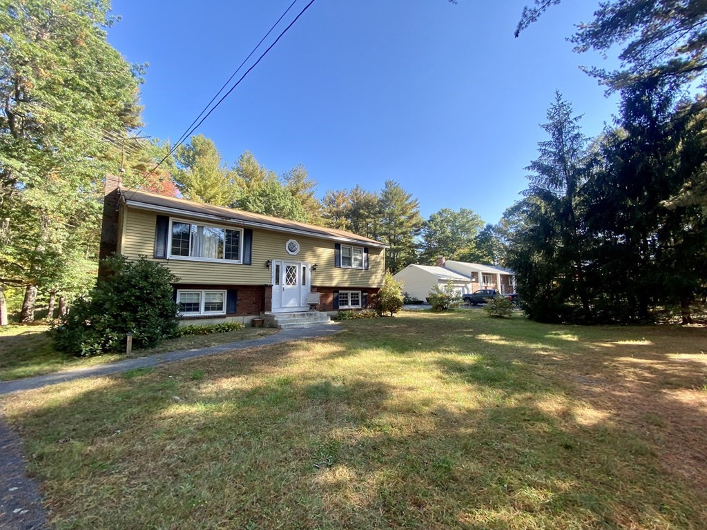 16 Peabody Road Shirley, MA 01464 - Photo 2 of 20 a view of a house with a big yard and large trees