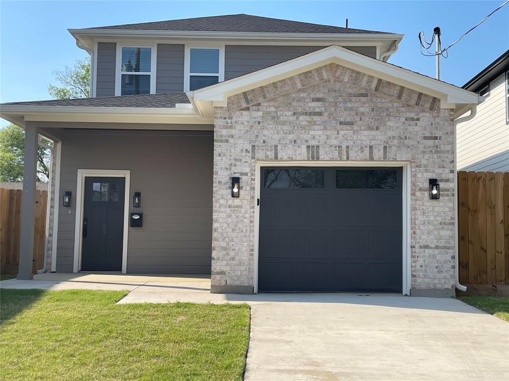 3535 Spring Avenue Dallas, TX 75210 - Photo 1 of 19 View of front facade featuring a garage, a porch, driveway, and brick siding