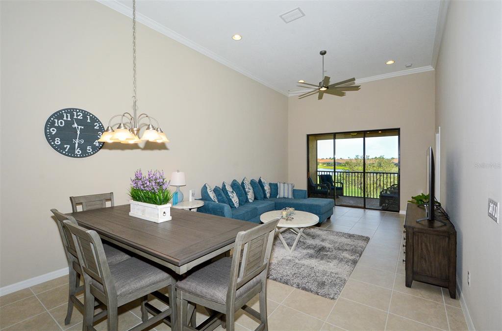 13737 Messina Loop, Unit 202 Lakewood Ranch, FL 34211 - Photo 8 of 49 a view of a dining room with furniture window and wooden floor