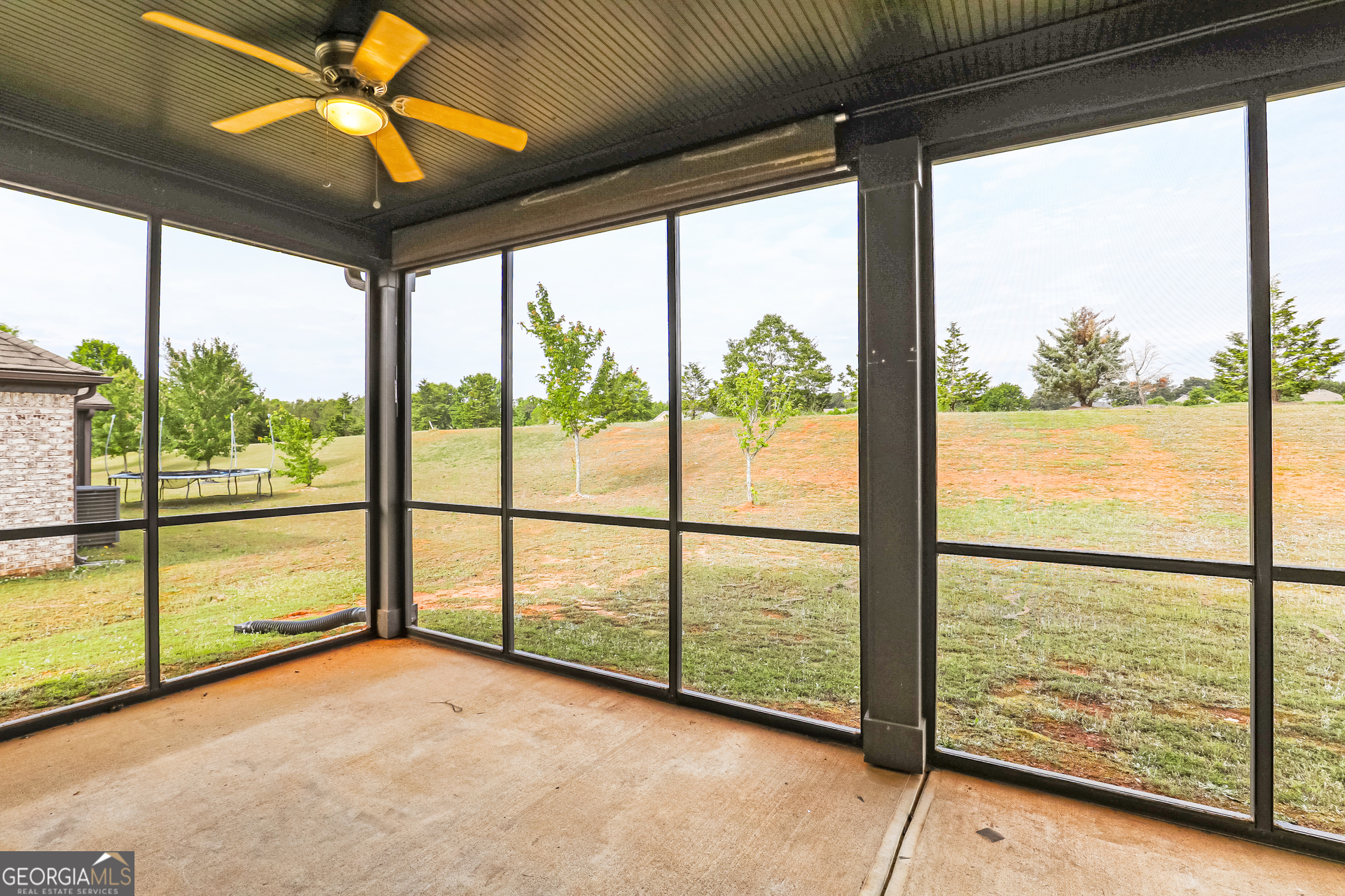 3216 Alhambra Circle Hampton, GA 30228 - Photo 9 of 21 a view of an empty room with a floor to ceiling windows with the ceiling fan