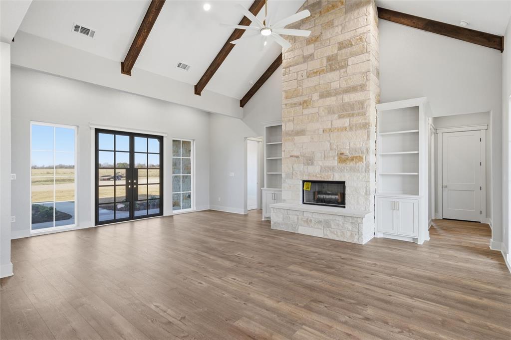 348 Lacek Mill Road China Spring, TX 76633 - Photo 13 of 40 an empty room with wooden floor and fireplace