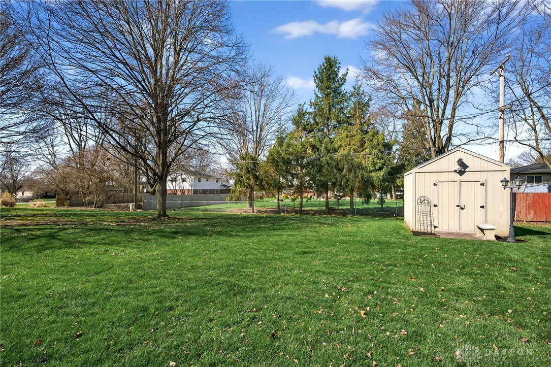 5907 Red Coach Road Dayton, OH 45429 - Photo 50 of 50 Expansive green lawn with a practical storage shed and mature trees.