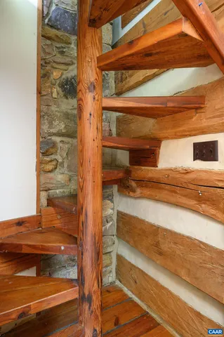 a view of a room with wooden floor and chair
