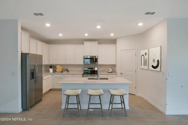 a kitchen with a table and chairs in it