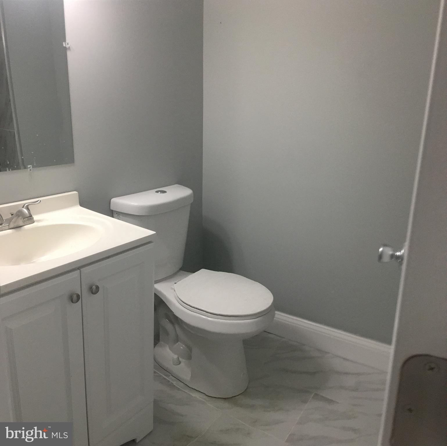 7441 Edsworth Road Baltimore, MD 21222 - Photo 31 of 37 a white toilet sitting next to a bathroom sink
