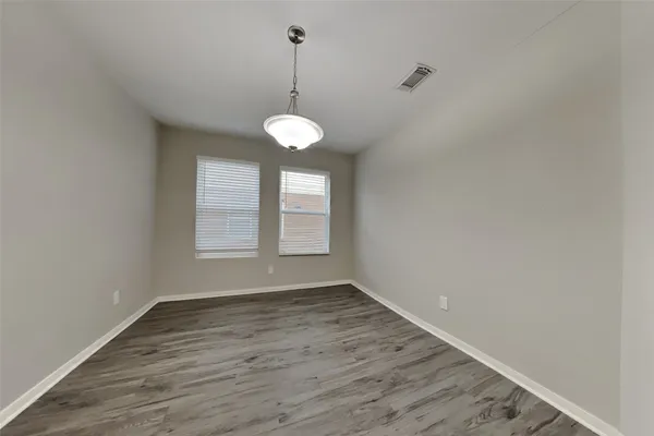a view of wooden floor and a chandelier in a room