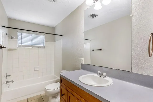 a bathroom with a sink vanity granite tub toilet and shower
