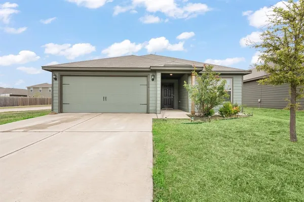a view of a house with a yard and garage