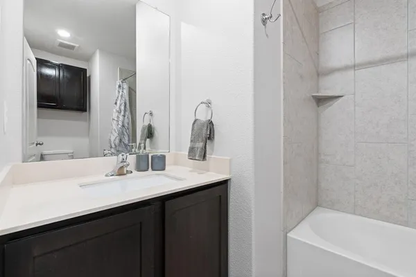 a bathroom with a double vanity sink and a bathtub