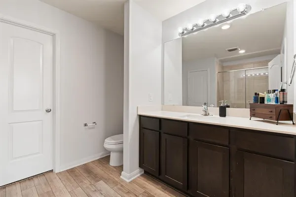 a bathroom with a double vanity sink mirror and toilet