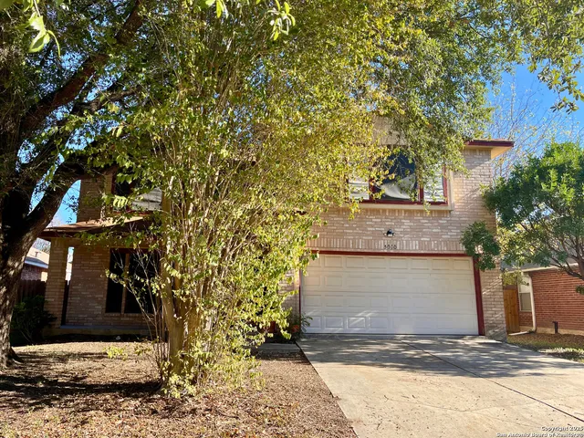 a view of a house with a tree