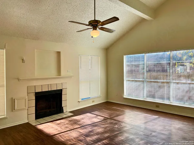 a view of a livingroom with a fireplace and window