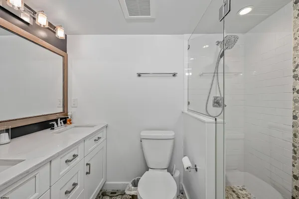 a bathroom with a toilet sink and shower