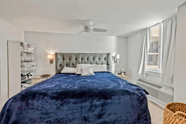 a bedroom with a large bed and a window