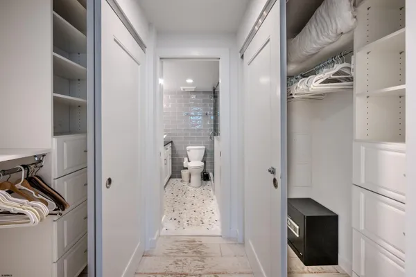 a bathroom with a shower and closet