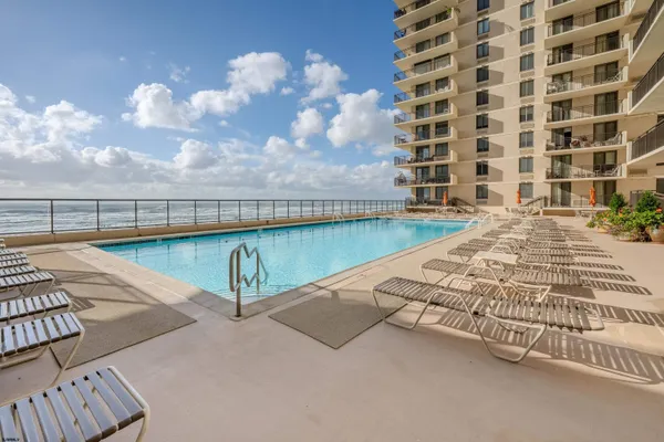 a view of a swimming pool with outdoor seating