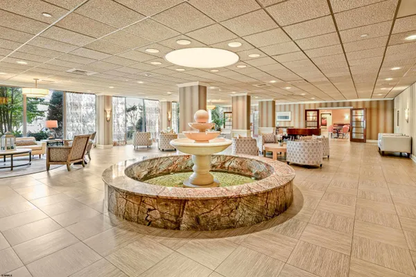 a large room with pool table and chairs