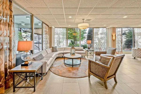 a living room with patio furniture and a large window