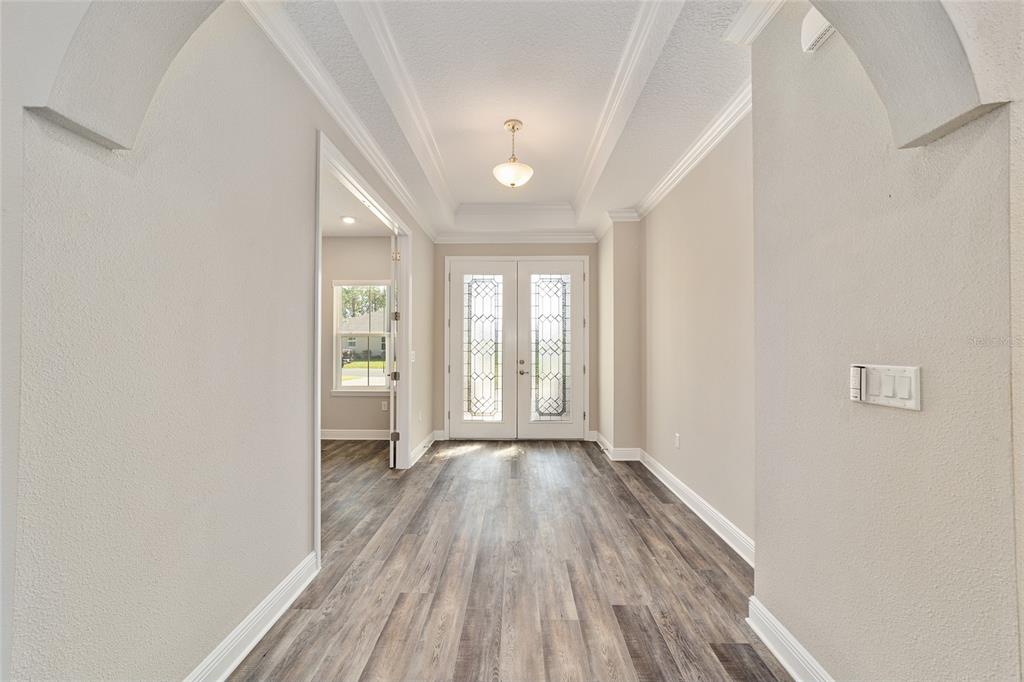 8176 Southwest 98th Terrace Road Ocala, FL 34481 - Photo 12 of 62 a view of an empty room with wooden floor and a window