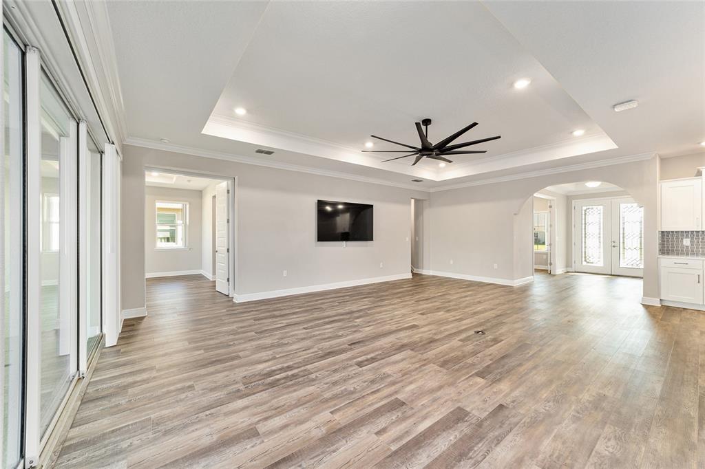 8176 Southwest 98th Terrace Road Ocala, FL 34481 - Photo 15 of 62 a view of a livingroom with wooden floor and a ceiling fan