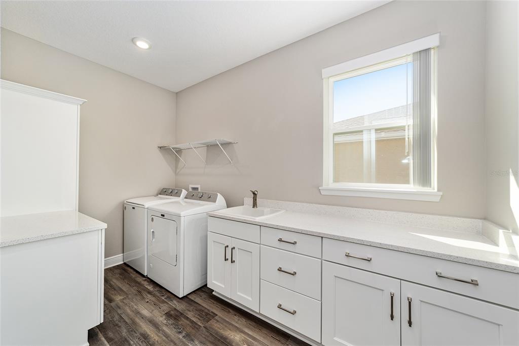 8176 Southwest 98th Terrace Road Ocala, FL 34481 - Photo 48 of 62 a utility room with cabinets washer and dryer